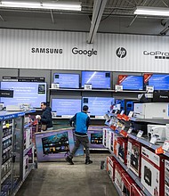 A worker stocks televisions at a Walmart store on Black Friday in Secaucus, New Jersey, US, on Friday, Nov. 24, 2023.
Mandatory Credit:	Victor J. Blue/Bloomberg/Getty Images