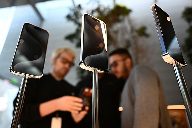 Apple iPhone 15 series devices are displayed for sale as a customer purchases an iPhone at The Grove Apple retail store on release day in Los Angeles, California, on September 22, 2023.
Mandatory Credit:	Patrick T. Fallon/AFP/Getty Images