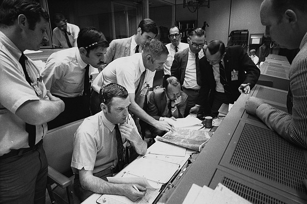 Flight controllers gather around NASA Flight Director Glynn Lunney (seated, foreground) in the control room at what's now called Johnson Space Center in Houston during the Apollo 13 aborted lunar landing mission, on April 15, 1970.
Mandatory Credit:	Space Frontiers/Archive Photos/Getty Images via CNN Newsource