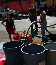 People fill buckets from a water tanker in the Azcapotzalco neighborhood in Mexico City on January 26.
Mandatory Credit:	Henry Romero/Reuters via CNN Newsource
