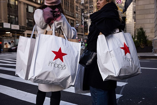 Macy's is closing 150 stores; seen here, shoppers carry Macy's bags during "Black Friday" in New York in November 2023.
Mandatory Credit:	Yuki Iwamura/AFP/Getty Images via CNN Newsource