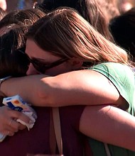 People hug at a vigil for Laken Hope Riley at the University of Georgia in Athens, Georgia, on February 26.
Mandatory Credit:	WANF via CNN Newsource
