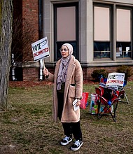 A volunteeer holds a "Vote Uncommitted" sign outside a polling station in Dearborn, Michigan, on February 27.
Mandatory Credit:	Nic Antaya/Bloomberg/Getty Images via CNN Newsource