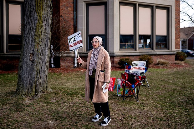 A volunteeer holds a "Vote Uncommitted" sign outside a polling station in Dearborn, Michigan, on February 27.
Mandatory Credit:	Nic Antaya/Bloomberg/Getty Images via CNN Newsource