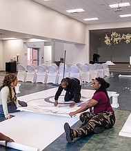 Ashley Armstrong, Kiara Solice, Ronald Jackson and Kailynn Archer put the final touches on a banner for a wedding in one of the multipurpose rooms at Beaulah Recreation Center in Chesterfield County, which opened in 2023.