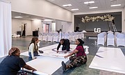 Ashley Armstrong, Kiara Solice, Ronald Jackson and Kailynn Archer put the final touches on a banner for a wedding in one of the multipurpose rooms at Beaulah Recreation Center in Chesterfield County, which opened in 2023.