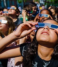 Students wear protective glasses to view a partial solar eclipse over Schiedam, Netherlands, in June 2021.
Mandatory Credit:	Marco de Swart/ANP/AFP/Getty Images via CNN Newsource