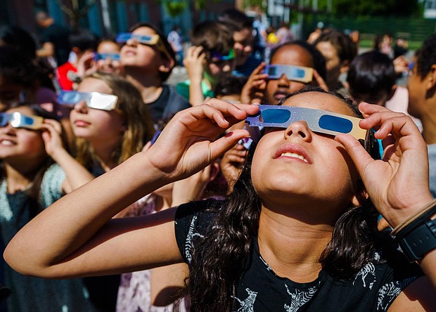 Students wear protective glasses to view a partial solar eclipse over Schiedam, Netherlands, in June 2021.
Mandatory Credit:	Marco de Swart/ANP/AFP/Getty Images via CNN Newsource