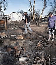 Tia Champion and her husband Tim help a friend search the remains of her home near Stinnett, Texas, after it was destroyed by the Smokehouse Creek Fire.
Mandatory Credit:	Scott Olson/Getty Images via CNN Newsource