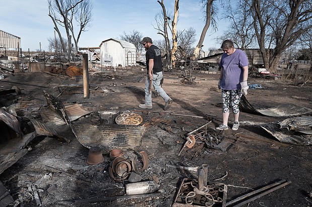 Tia Champion and her husband Tim help a friend search the remains of her home near Stinnett, Texas, after it was destroyed by the Smokehouse Creek Fire.
Mandatory Credit:	Scott Olson/Getty Images via CNN Newsource
