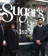 (L-R) Mark Geil, interim chair for JSU's Department of Art, with graphic design students Ashanti Stiff, Michael Brown, and Tyler Tremble in front of Sugar's Place downtown Jackson. Stiff created the logo and redesign for Sugar's Place. (William H. Kelly III/Jackson State University)