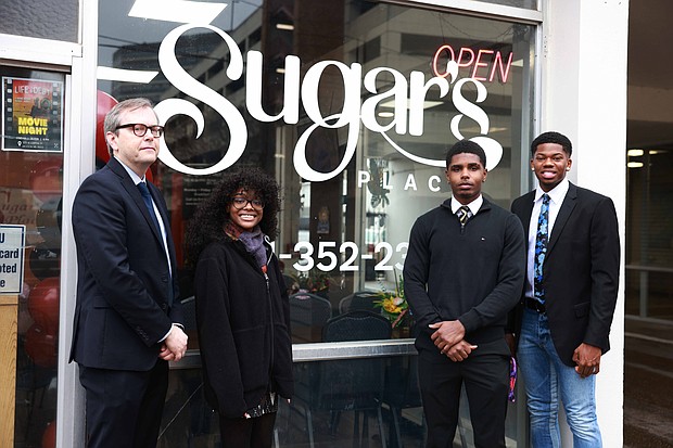 (L-R) Mark Geil, interim chair for JSU's Department of Art, with graphic design students Ashanti Stiff, Michael Brown, and Tyler Tremble in front of Sugar's Place downtown Jackson. Stiff created the logo and redesign for Sugar's Place. (William H. Kelly III/Jackson State University)