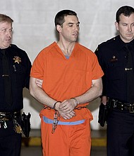 Convicted murderer Scott Peterson is escorted from jail on March 17, 2005, in Redwood City, California.
Mandatory Credit:	Justin Sullivan/Getty Images via CNN Newsource