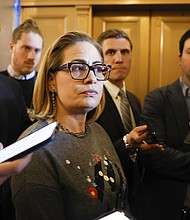 Sen Kyrsten Sinema, here talking to reporters on January 25, announced Tuesday that she will retire at the end of her term this year.
Mandatory Credit:	Anna Moneymaker/Getty Images via CNN Newsource