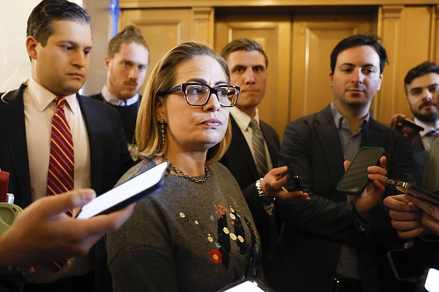 Sen Kyrsten Sinema, here talking to reporters on January 25, announced Tuesday that she will retire at the end of her term this year.
Mandatory Credit:	Anna Moneymaker/Getty Images via CNN Newsource