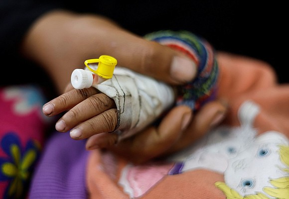 Anwar Abdul Nabi perches on the edge of a bed at the Kamal Adwan Hospital in northern Gaza. Her eyes …