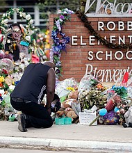 Reggie Daniels pays his respects at a memorial at Robb Elementary School on June 9, 2022, in Uvalde, Texas.
Mandatory Credit:	Eric Gay/AP via CNN Newsource