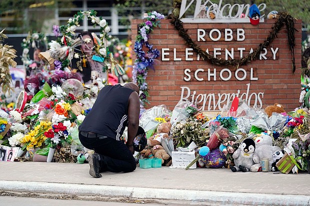 Reggie Daniels pays his respects at a memorial at Robb Elementary School on June 9, 2022, in Uvalde, Texas.
Mandatory Credit:	Eric Gay/AP via CNN Newsource