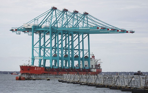 Four fully-assembled, 170-foot tall ship-to-shore ZPMC cranes on the Elizabeth River in January 2019. Some Chinese-made cranes used at US ports contain communications equipment with no clear purpose or record of their installation, according to a new congressional investigation that will heighten US concerns that the cranes could be used for surveillance or sabotage.
Mandatory Credit:	L. Todd Spencer/The Virginian-Pilot/Getty Images via CNN Newsource