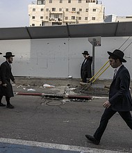Ultra-Orthodox Jewish men walk in the central Israeli city of Bnei Brak on February 27.
Mandatory Credit:	Menahem Kahana/AFP/Getty Images via CNN Newsource