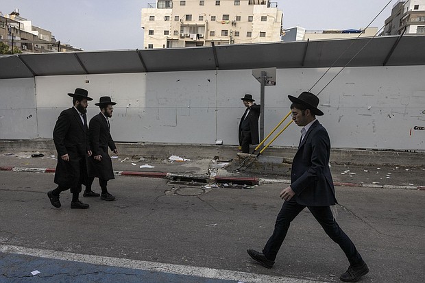 Ultra-Orthodox Jewish men walk in the central Israeli city of Bnei Brak on February 27.
Mandatory Credit:	Menahem Kahana/AFP/Getty Images via CNN Newsource