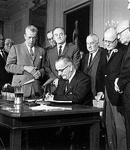 President Lyndon Baines Johnson signs the Civil Rights Act on July 2, 1964. The law made it illegal to discriminate on the basis of race, color, religion, sex, or national origin, and barred unequal application of voter registration requirements.
Mandatory Credit:	AP via CNN Newsource