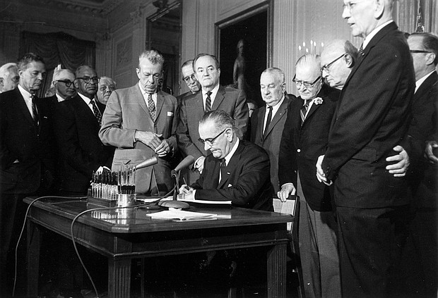 President Lyndon Baines Johnson signs the Civil Rights Act on July 2, 1964. The law made it illegal to discriminate on the basis of race, color, religion, sex, or national origin, and barred unequal application of voter registration requirements.
Mandatory Credit:	AP via CNN Newsource
