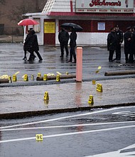 Evidence markers are seen following a shooting in Northeast Philadelphia on March 6. Two 18-year-olds have been arrested for allegedly unleashing a hail of gunfire at high school students waiting at a bus stop in Northeast Philadelphia, leaving eight injured.
Mandatory Credit:	Joe Lamberti/AP via CNN Newsource