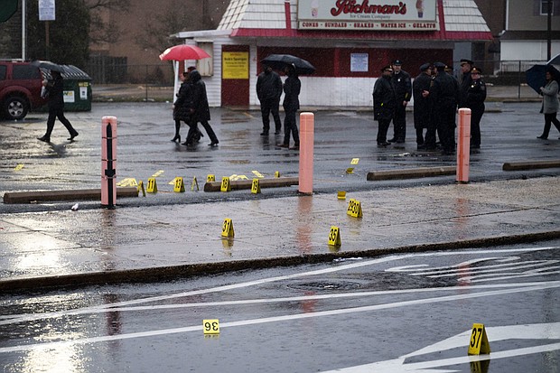 Evidence markers are seen following a shooting in Northeast Philadelphia on March 6. Two 18-year-olds have been arrested for allegedly unleashing a hail of gunfire at high school students waiting at a bus stop in Northeast Philadelphia, leaving eight injured.
Mandatory Credit:	Joe Lamberti/AP via CNN Newsource