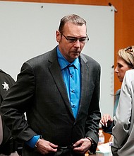 James Crumbley is escorted out of the Oakland County courtroom Friday in Pontiac, Michigan.
Mandatory Credit:	Carlos Osorio/Pool/AP via CNN Newsource