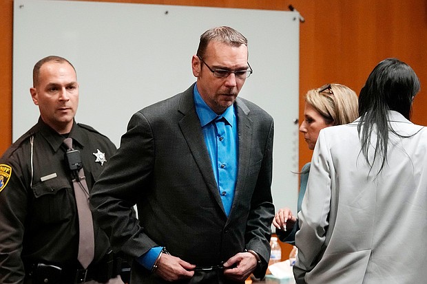 James Crumbley is escorted out of the Oakland County courtroom Friday in Pontiac, Michigan.
Mandatory Credit:	Carlos Osorio/Pool/AP via CNN Newsource