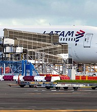The LATAM Airlines Boeing 787 Dreamliner plane that suddenly lost altitude mid-flight on the tarmac of the Auckland International Airport on March 12.
Mandatory Credit:	BRETT PHIBBS/AFP/AFP via Getty Images via CNN Newsource