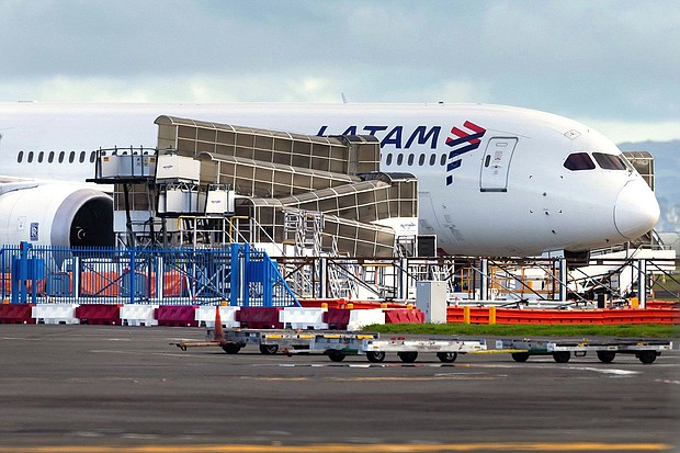 The LATAM Airlines Boeing 787 Dreamliner plane that suddenly lost altitude mid-flight on the tarmac of the Auckland International Airport on March 12.
Mandatory Credit:	BRETT PHIBBS/AFP/AFP via Getty Images via CNN Newsource