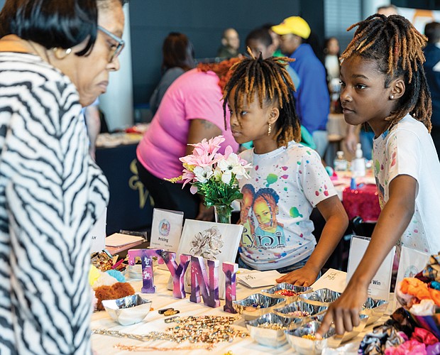 Twins Tyra (right) and Toni (left) Thompson, age 11, represent their Tyni Accessories business during the Children’s Business Fair on Sunday, March 10, at the Dewey Gottwald Center on Leigh Street. The Thompson twins launched their business three years ago. Their products include accessories such as scrunchies and custom made bracelets.