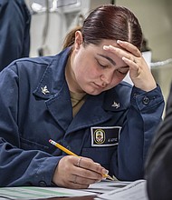 Quartermaster 3rd Class Jacklyn Lopez, a native of Houston, participates in the E-5 Navy-Wide Advancement Exam on the mess decks aboard USS Boxer (LHD 4), March 14, 2024. Boxer is a Wasp-class amphibious assault ship homeported in San Diego. (U.S. photo by Mass Communication Specialist 2nd Class James Finney)