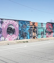 Local muralist Ed Trask recently completed a major undertaking on the old Bellevue Cleaners’ wall that celebrates various aspect of Richmond’s “NORTHSIDE” at the Corner of Brook Road and Bellvue Avenue.
The mural is a colorful and intimate salute to Richmond’s North Side neighborhoods.
Mr. Trask is a musician, painter and well-known muralist whose work can be seen in various other neighborhoods across the city. His work, both his paintings and murals, are in numerous permanent collections including the Virginia Museum of Fine Arts.