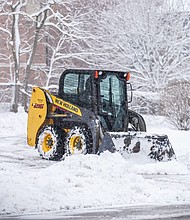 A skid steer clears a driveway in Pewaukee on Friday morning after a spring storm dumped snow across the area.
Mandatory Credit:	Scott Ash/Milwaukee Jourrnal/USA Today via CNN Newsource