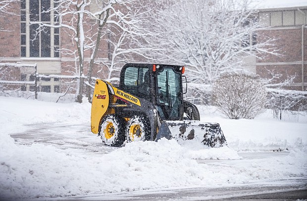 A skid steer clears a driveway in Pewaukee on Friday morning after a spring storm dumped snow across the area.
Mandatory Credit:	Scott Ash/Milwaukee Jourrnal/USA Today via CNN Newsource