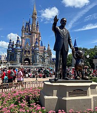 People gather at the Magic Kingdom theme park in Orlando, Florida, in 2022. Disney and Florida have agreed to a settlement.
Mandatory Credit:	Octavio Jones/Reuters/File via CNN Newsourc