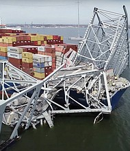 The collapsed Francis Scott Key Bridge over the Patapsco River in Baltimore on Tuesday. The bridge fell after the cargo ship Dali lost power and rammed a bridge support.