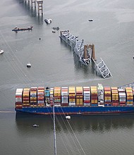 In an aerial view, the cargo ship Dali sits in the water after running into and collapsing the Francis Scott Key Bridge on March 26, in Baltimore, Maryland.
Mandatory Credit:	Tasos Katopodis/Getty Images via CNN Newsource