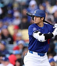 Ohtani prepares for a pitch during the Dodgers' preseason game against the Los Angeles Angels.
Mandatory Credit:	Harry How/Getty Images via CNN Newsource