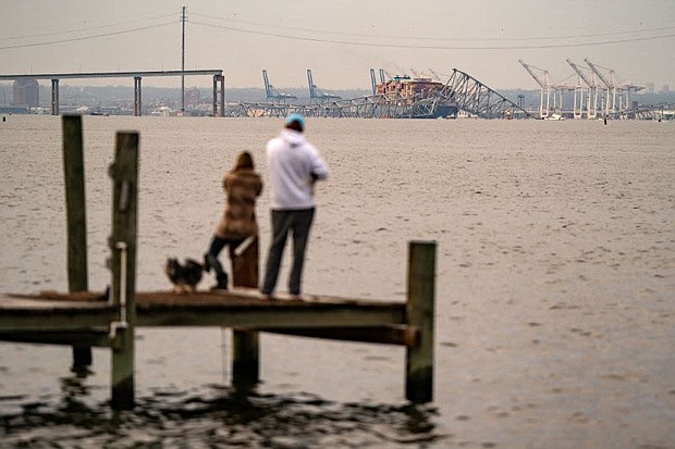 Onlookers check out the Francis Scott Key Bridge following its collapse early Tuesday in Baltimore.
Mandatory Credit:	Kent Nishimura/AFP/Getty Images via CNN Newsource