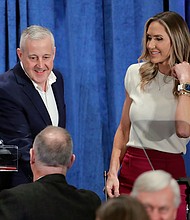 Newly-elected Chairman Michael Whatley, left, and Co-Chair Lara Trump, right, greet attendees as they crowd the podium after the general session of the Republican National Committee Spring Meeting, March 8, in Houston.
Mandatory Credit:	Michael Wyke/AP via CNN Newsource