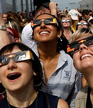People watch the 2017 solar eclipse from the observation deck of The Empire State Building in New York City.
Mandatory Credit:	Brendan McDermid/Reuters/File via CNN Newsource