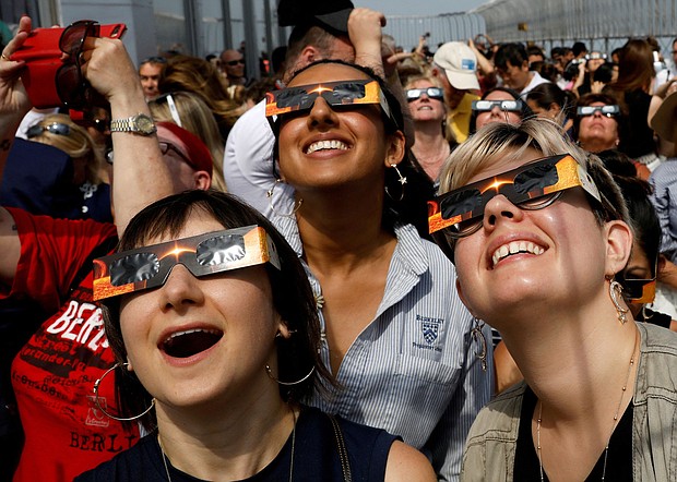 People watch the 2017 solar eclipse from the observation deck of The Empire State Building in New York City.
Mandatory Credit:	Brendan McDermid/Reuters/File via CNN Newsource