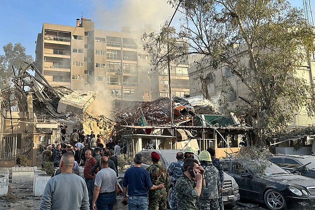 Emergency and security personnel gather at the site of strikes in Syria's capital Damascus, on April 1.
Mandatory Credit:	Maher Al Mounes/AFP/Getty Images via CNN Newsource