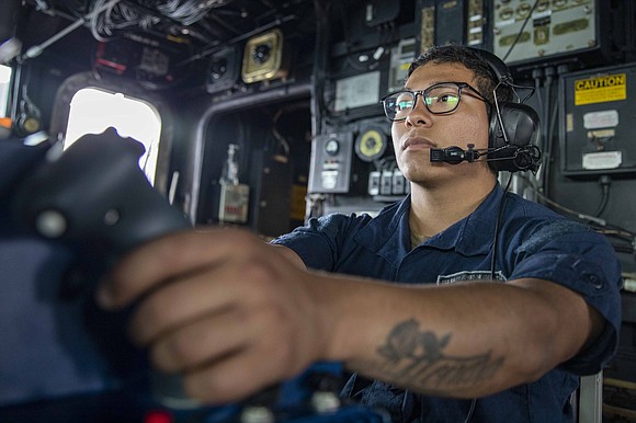 Gunner’s Mate 3rd Class Robert Mora, from Houston, participates in a live-fire exercise aboard the Arleigh Burke-class guided-missile destroyer USS …