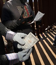 A Border Vets volunteer holds a Chinese Passport found at the US-Mexico border on February 29, in Jacumba Hot Springs, California.
Mandatory Credit:	Sandy Huffaker/Getty Images/File via CNN Newsource