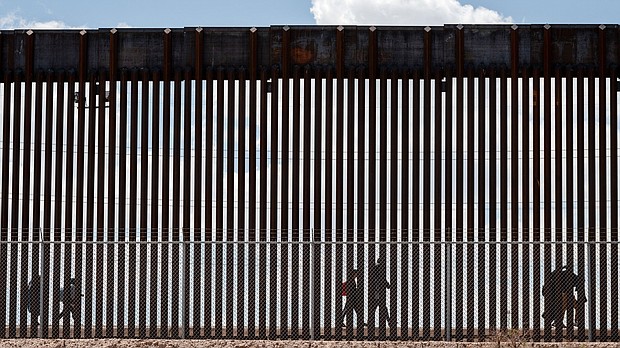 Migrants walk along the Mexico-US border after the the Republican-backed Texas law known as SB 4 took effect on March 19.
Mandatory Credit:	Justin Hamel/Reuters via CNN Newsource